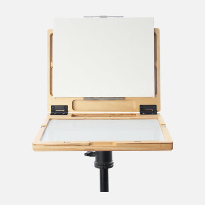 u.go Plein Air Anywhere Pochade Box, 8.4" x 11.25" model, on tripod with canvas panel