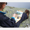 u.go Plein Air Anywhere Pochade Box, 6" x 8" model, on lap atop a mountain while plein air landscape painting
