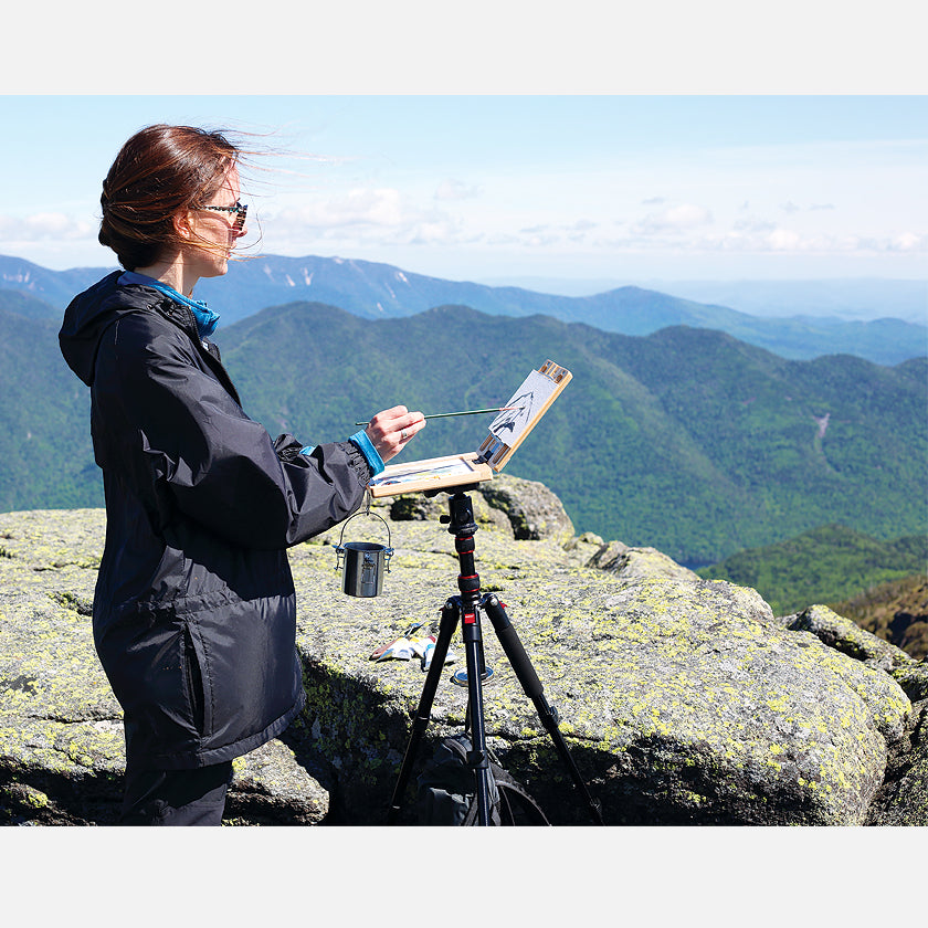 u.go Plein Air Anywhere Pochade Box, 6" x 8" model, on tripod plein air painting on a mountain peak